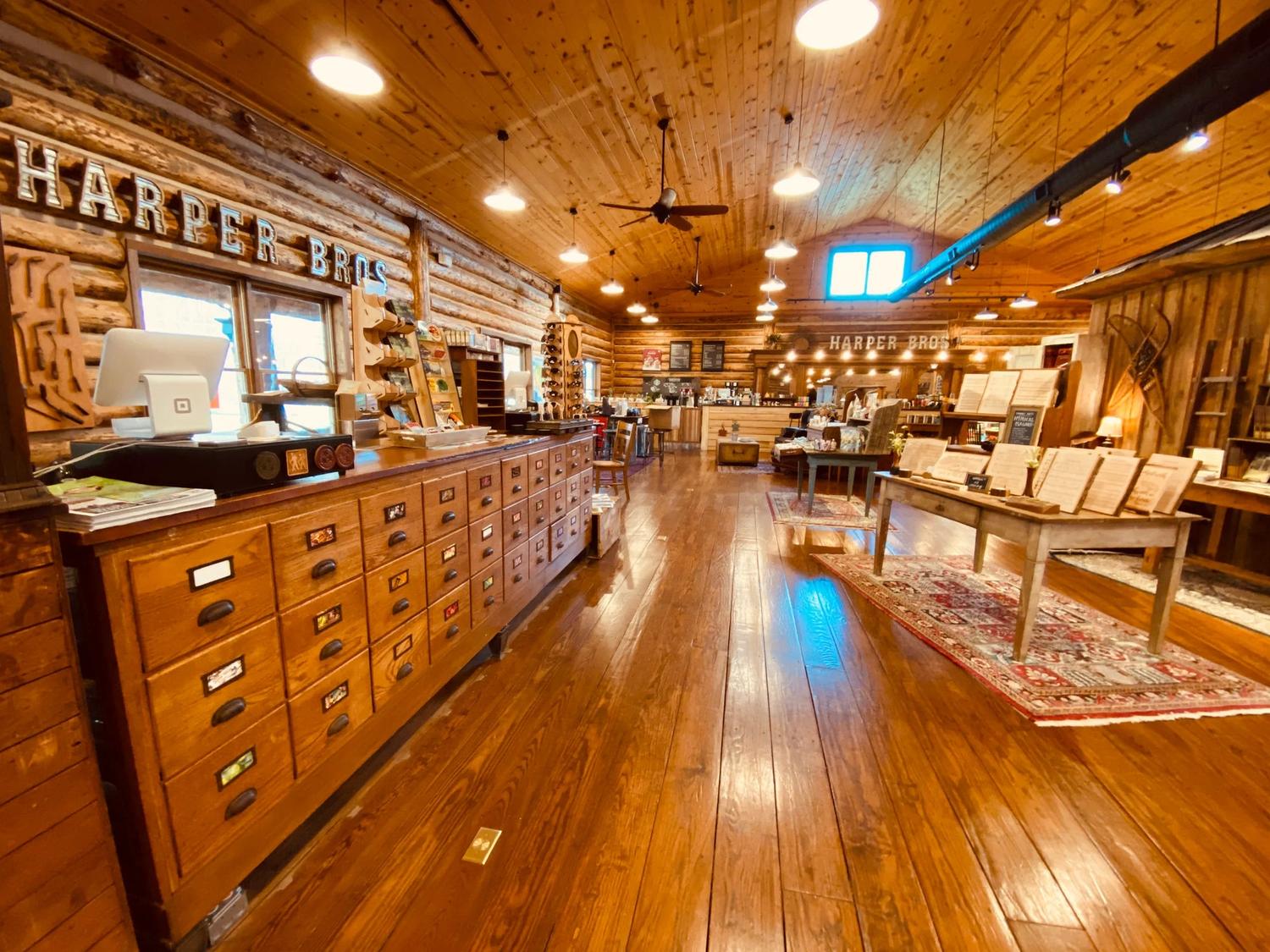 Harper Bros. general-store interior in Sevierville, Tennessee, with the HARPER BROS sign on the log wall.